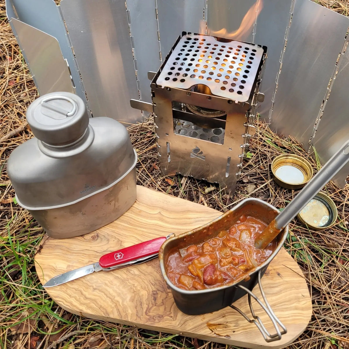SilverAnt Titanium Canteen Military Mess Kit with stove at an outdoor campsite