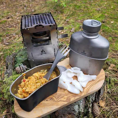 SilverAnt Titanium Canteen Military Mess Kit in outdoor setting with food and portable stove