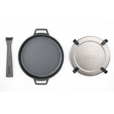 Ooni Cast Iron Skillet Pan with detachable handle and lid, perfect for outdoor cooking and high-heat culinary adventures.