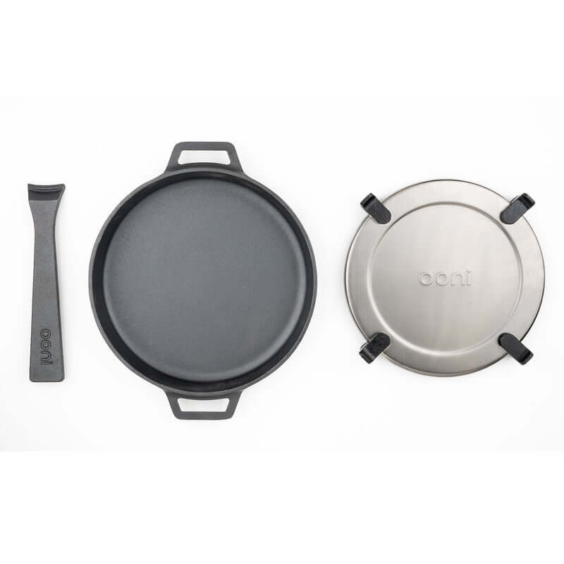 Ooni Cast Iron Skillet Pan with detachable handle and lid, perfect for outdoor cooking and high-heat culinary adventures.