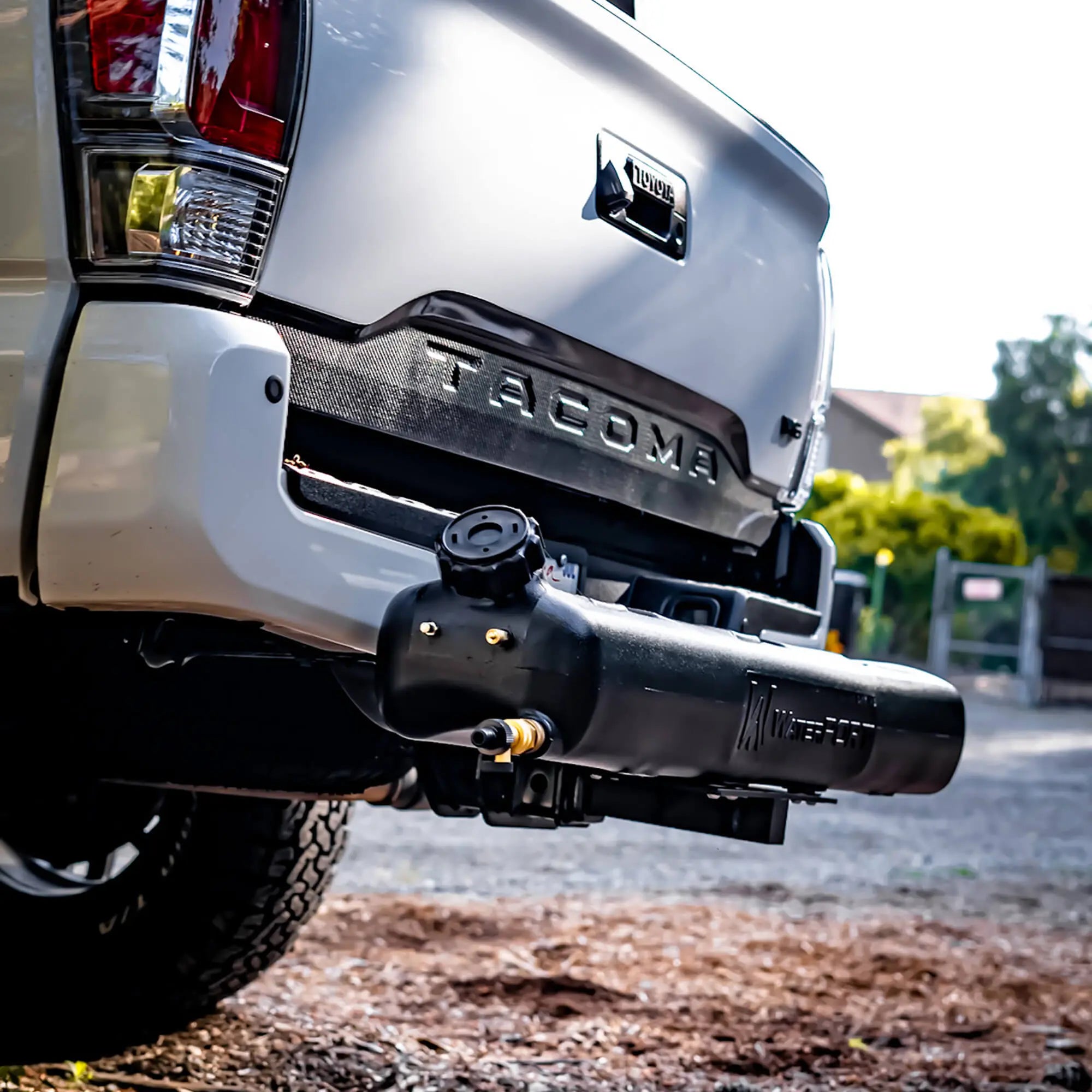 WaterPORT Hitch Mount Kit for 8 Gallon Weekender Tank attached to a truck, outdoor setting