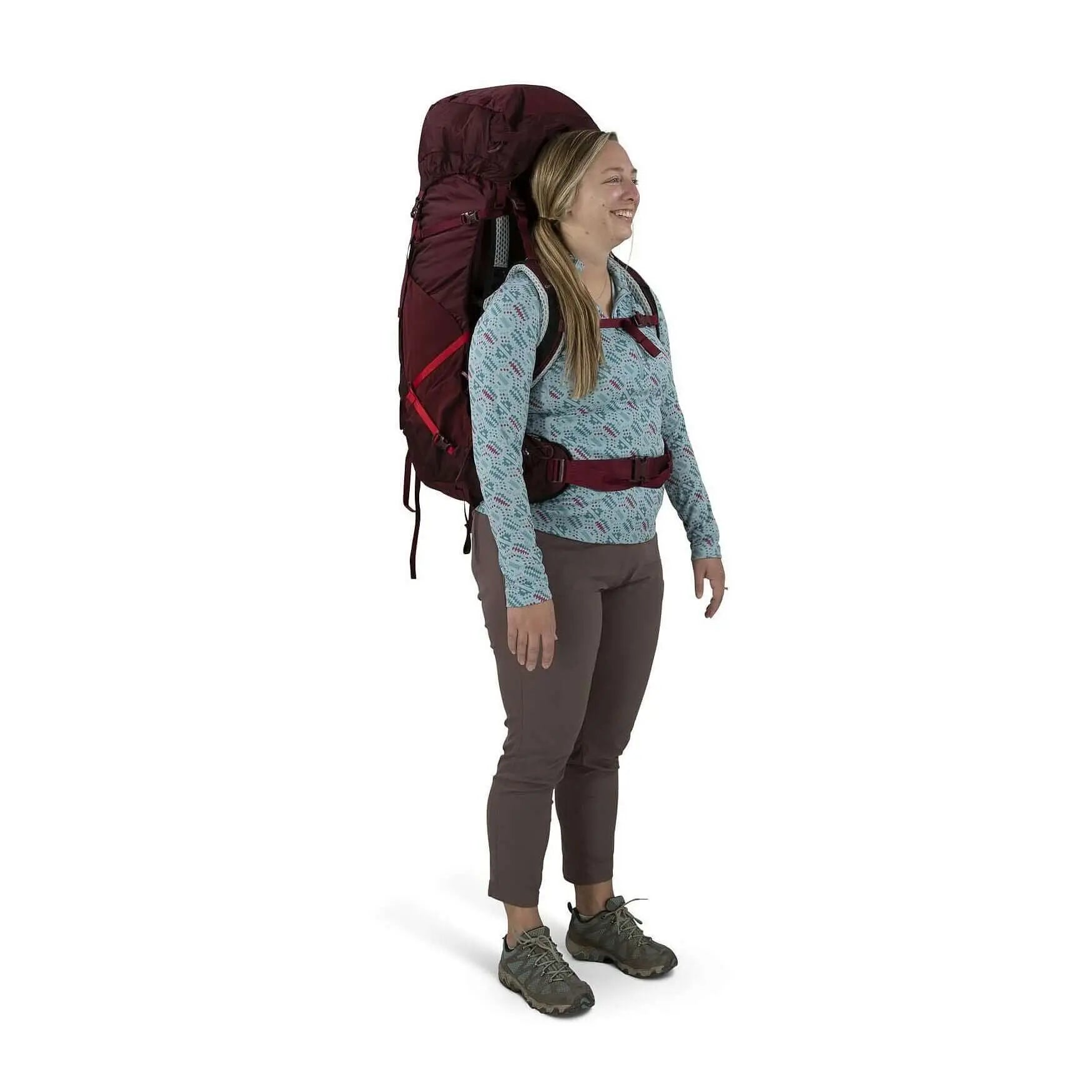 Woman wearing Osprey Aura AG LT 65 - Women backpack, showcasing lightweight comfort and capacity.