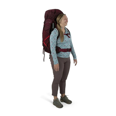 Woman wearing Osprey Aura AG LT 65 - Women backpack, showcasing lightweight comfort and capacity.