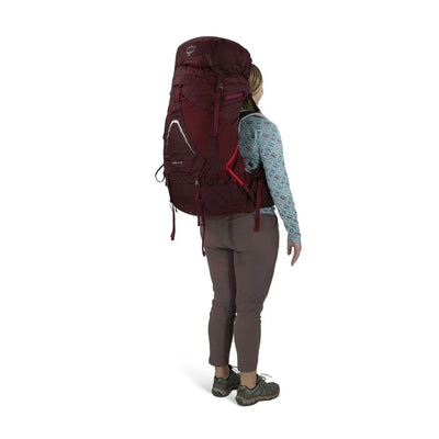 Woman wearing Osprey Aura AG LT 65 backpack for women, showcasing lightweight design and comfort for backcountry adventures.
