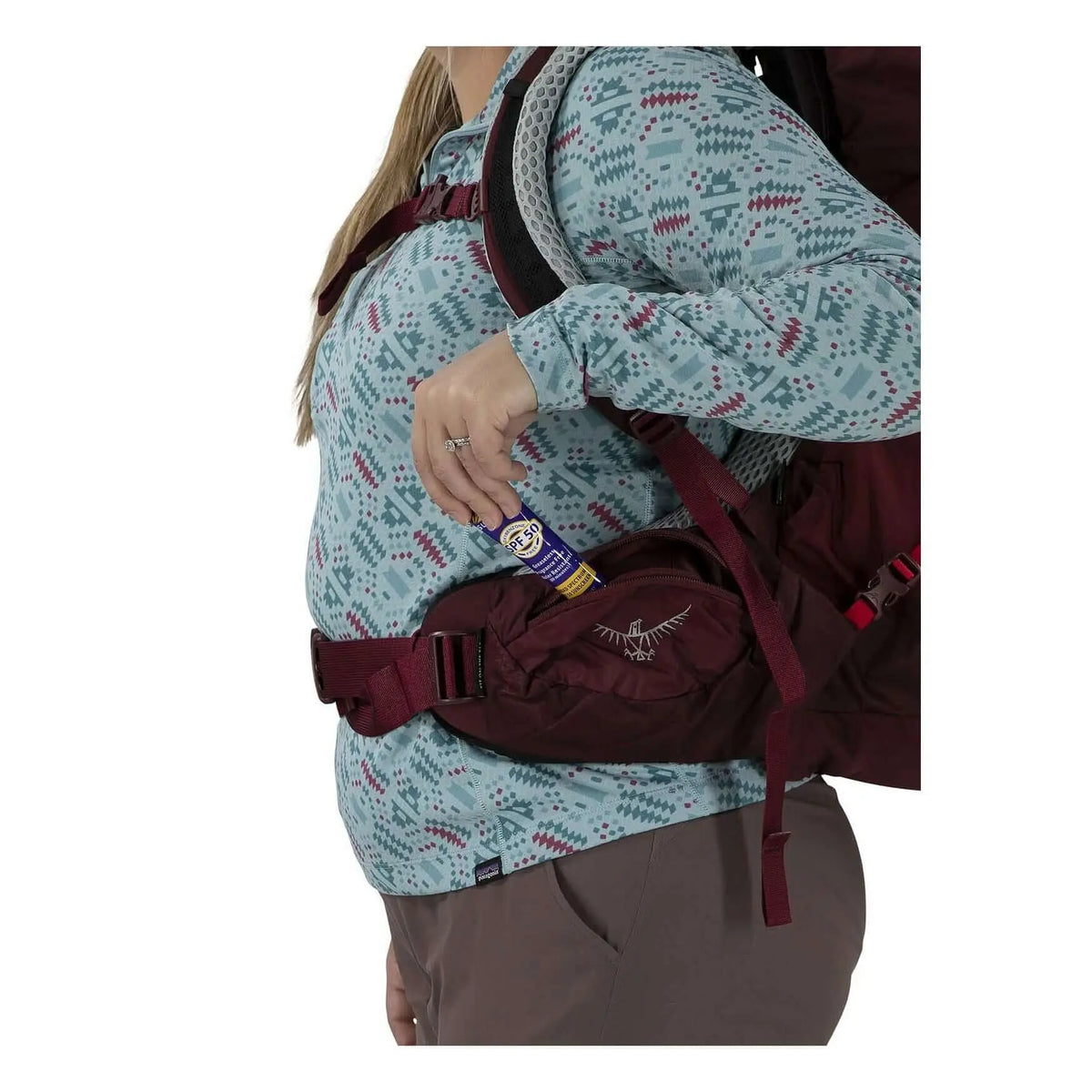 Woman wearing Osprey Aura AG LT 65 backpack showing side pocket feature