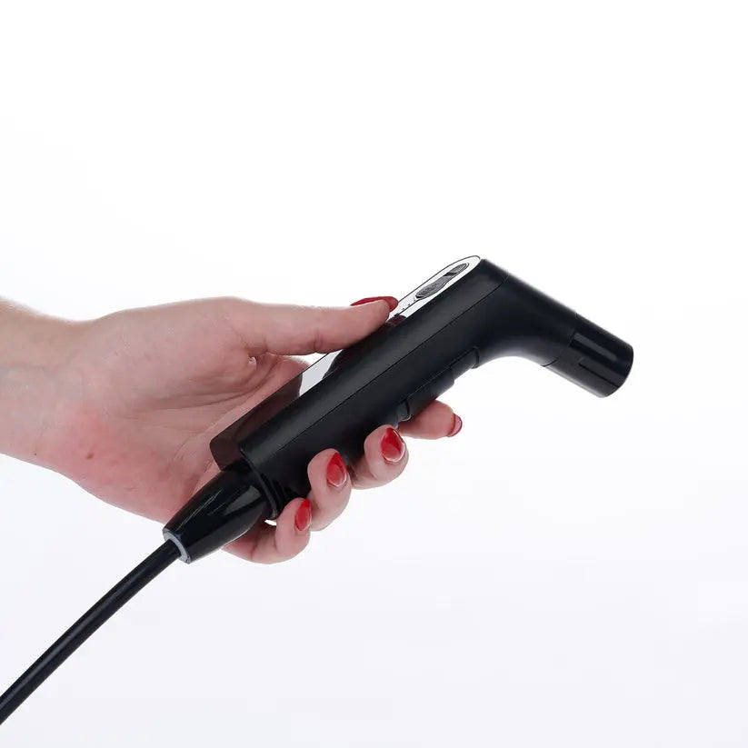 Person holding the Hygiene Collective Bliss rechargeable travel bidet nozzle.