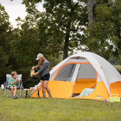 3 Person Dome Backpacking Tent - 7' x 7' set up with campers enjoying snacks and relaxing outside.