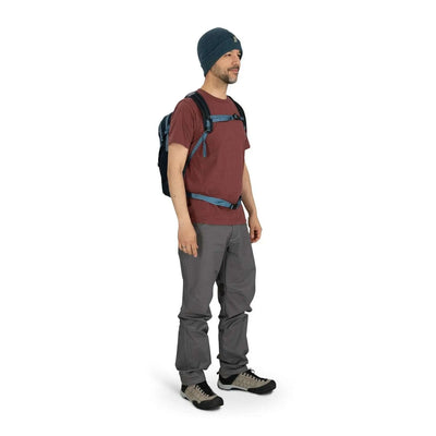 Man wearing Osprey Daylite backpack for hikes and errands, featuring sustainable materials and versatile attachment options.