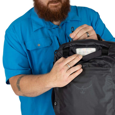 Person using the Transporter Squffel 44 backpack, showcasing its practical design for adventure.