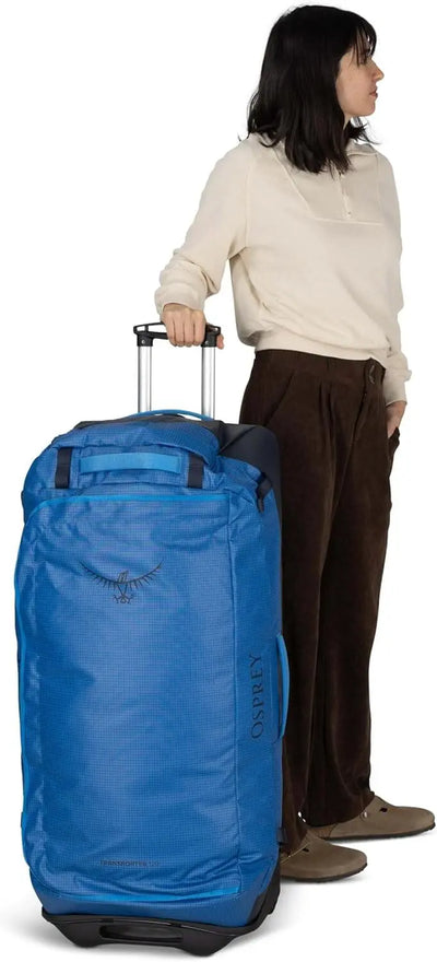 Transporter Wheeled Duffel 120 by Osprey in blue; ideal for rugged travel with oversized wheels and durable material.