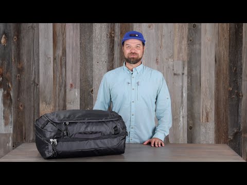 Transporter Squffel 44 bag showcased by a man in a rugged setting, emphasizing adventure and durability.
