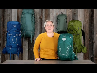 Model showcasing Osprey Talon 22 Extended Fit - Men backpack among similar packs, highlighting its design and features.