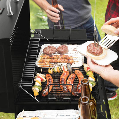 Royal Gourmet 28-Inch Barrel Charcoal Grill with Front Basket being used by people