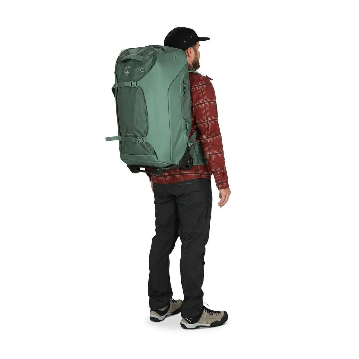 Man carrying Osprey Sojourn Shuttle Wheeled Duffel 25"/60L with StraightJacket straps, showcasing versatility, comfort, and lightweight design.