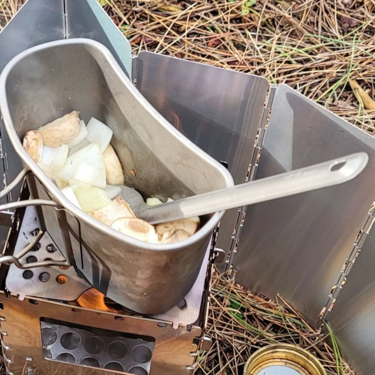 Cooking with SilverAnt Long Handle Titanium Spork in outdoor camp kitchen setup