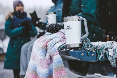 Classic Stay Chill Beer Pitcher - 64 oz / 1.9 L used for serving drinks outdoors in a snowy setting.