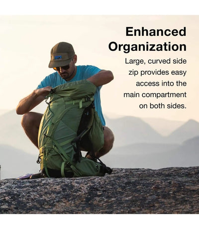 Man using Osprey Atmos AG 65 - Men backpack with enhanced organization on a mountain summit, showcasing large, curved side zip access.