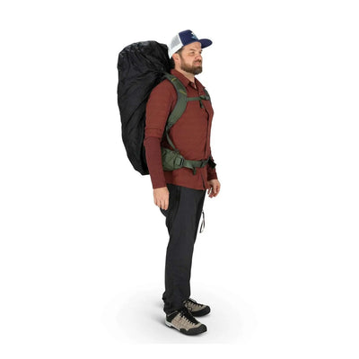 Man wearing a backpack with an Ultralight Raincover for outdoor protection, showcasing durable waterproof design.