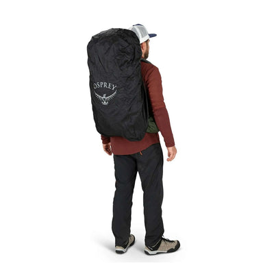 Ultralight Raincover by Osprey protecting backpack from rain in rugged outdoor setting.