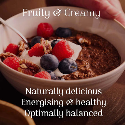 Veloforte Smooth Cocoa Complete Overnight Oats - 630g served with berries and yogurt in a bowl.