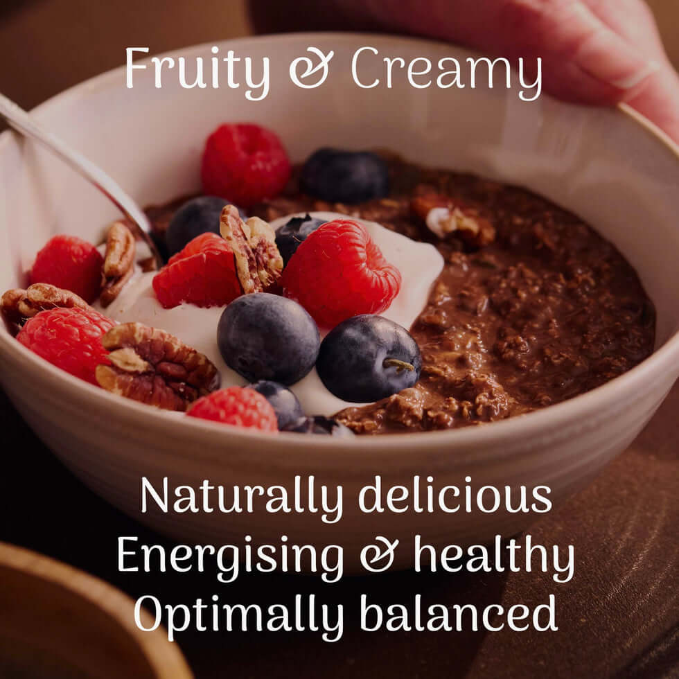Veloforte Smooth Cocoa Complete Overnight Oats - 630g served with berries and yogurt in a bowl.