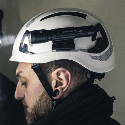 P5R mounted on a white safety helmet, showcasing compact design and powerful focus for everyday use.